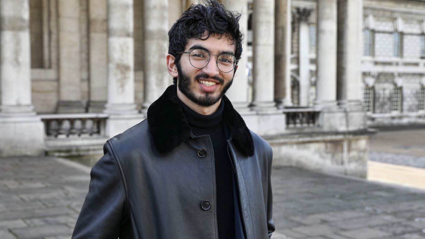 male student on campus smiling