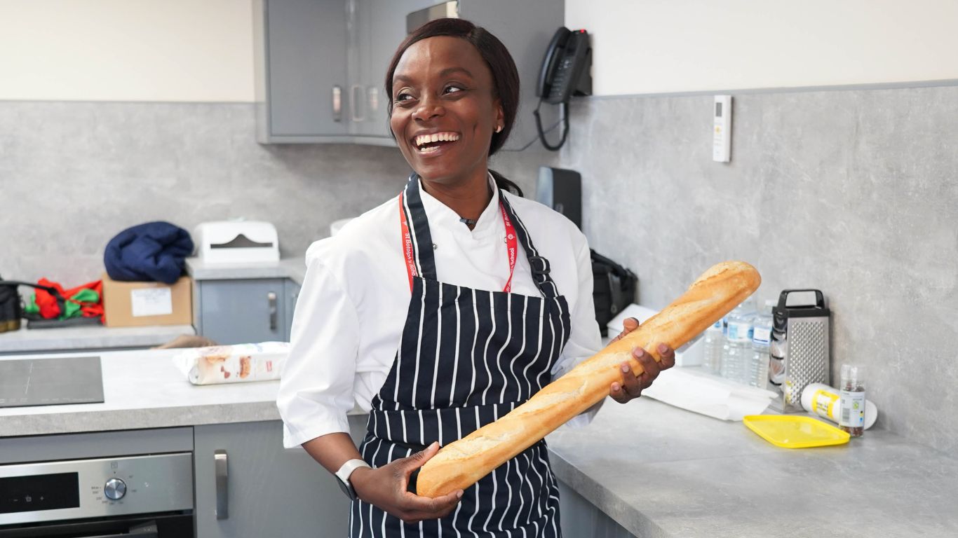 woman holding baguette