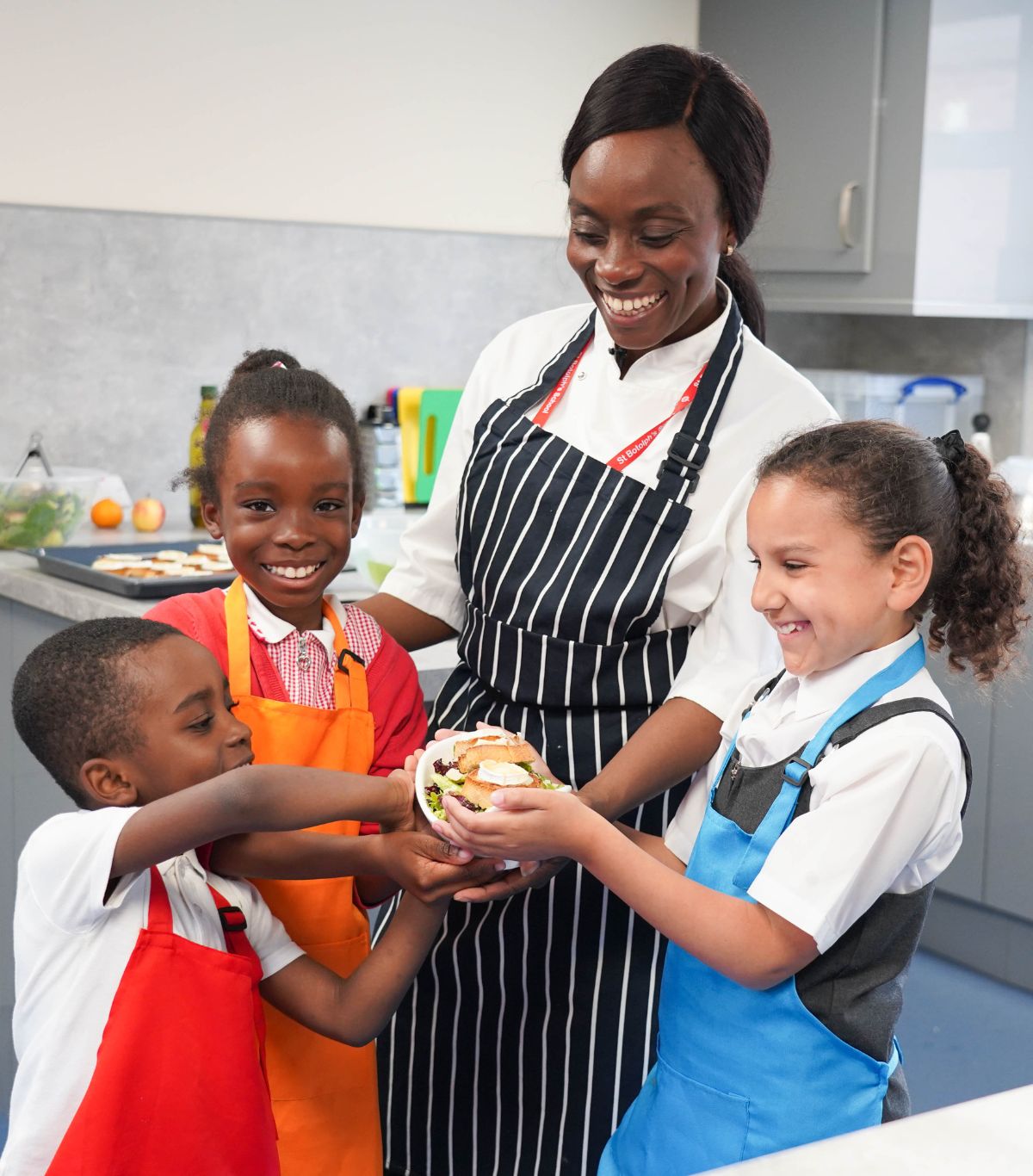 teacher and children holding food