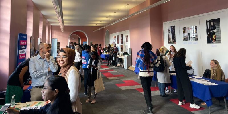 An image of students at the Careers and Recruitment Fair, networking with employers at stands.