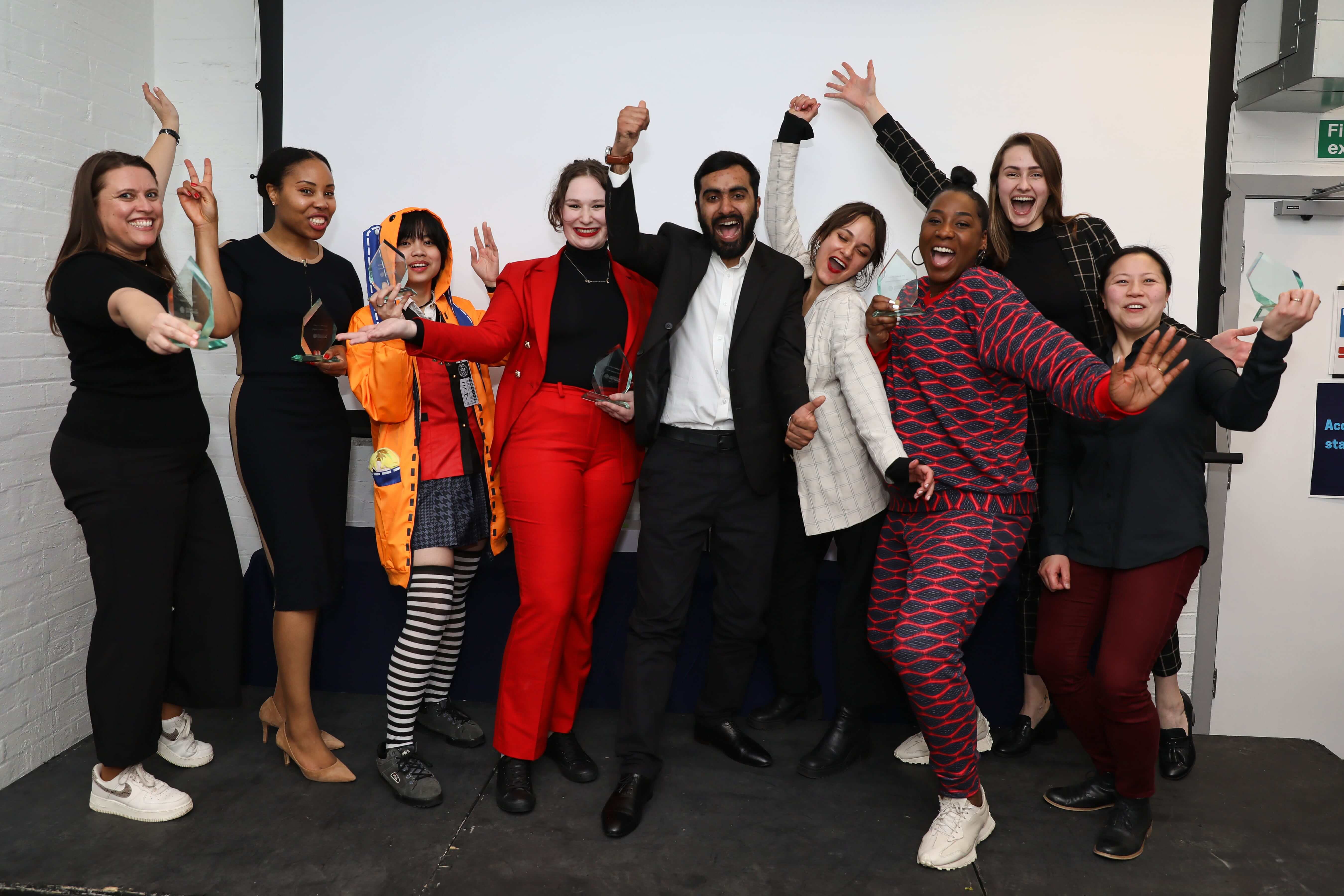 The University of Greenwich Enterprise Challenge winners 2023. All celebrating together with their trophies.