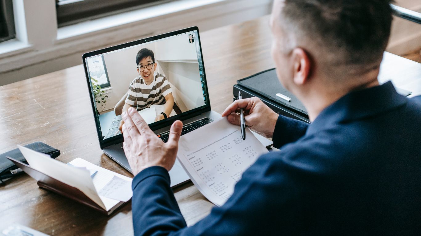 man at tesk having online meeting